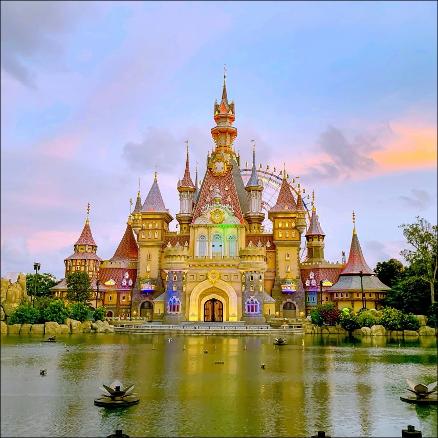 VinWonders-style castle and theme park at dusk, reflected in the water — Phu Quoc package